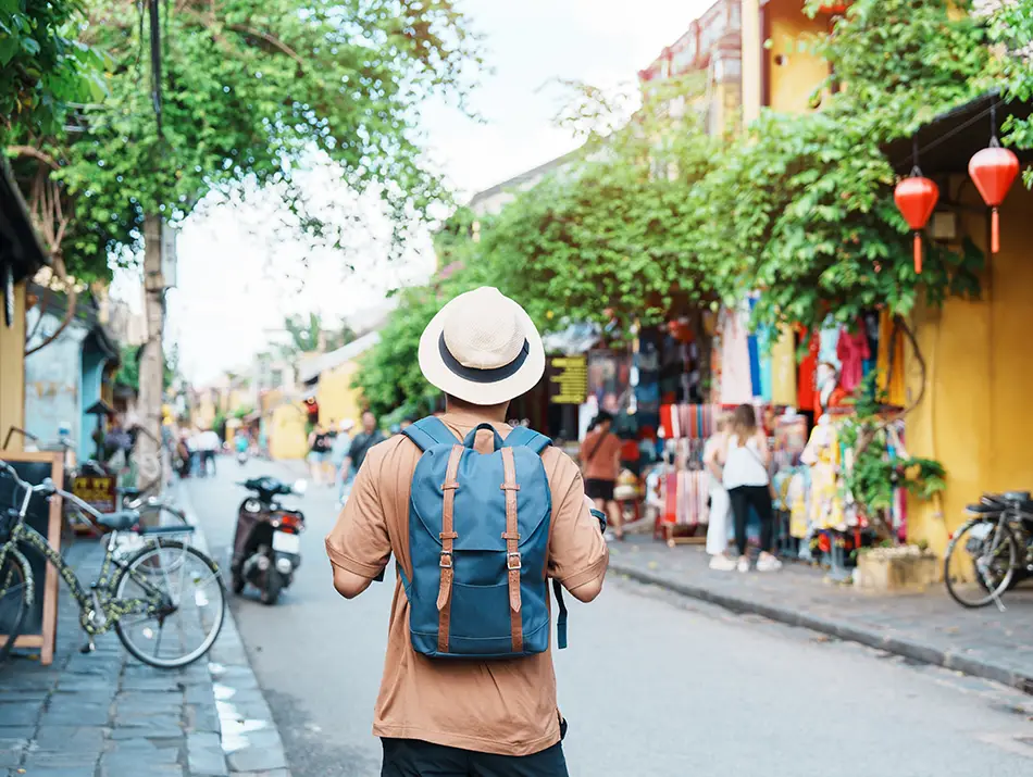 Backpacker walking a lively street.