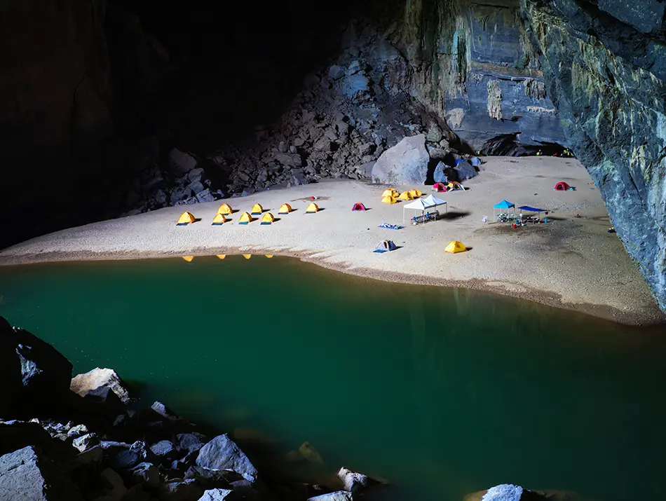 Hidden sandy beach inside a cave, ideal for Vietnam cave expedition for beginners.