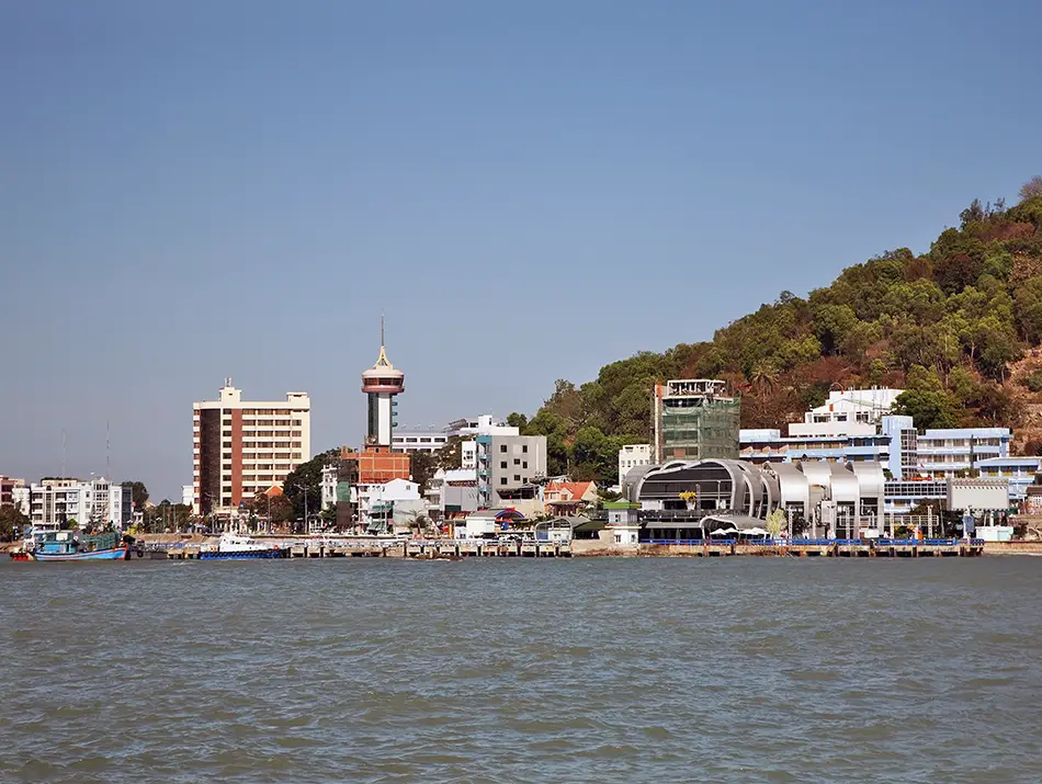 View from the sea toward the tourist area of Vung Tau, showing beachfront buildings and the coastal skyline.