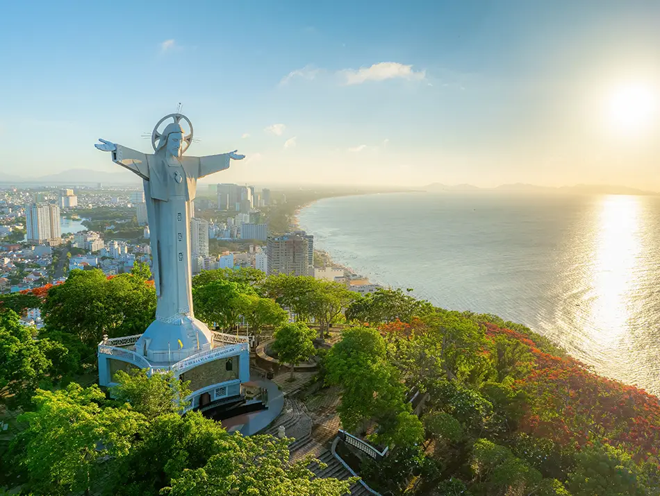 Drone shot of the Statue of Jesus Christ the King on Nho Mountain, highlighting it as a top attraction in Vung Tau.