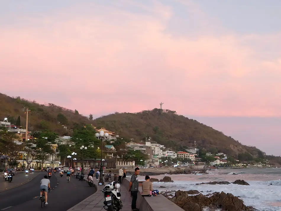 Sunset view from the Vung Tau waterfront with a Mountain and the distant silhouette of the Jesus Christ statue in the background.