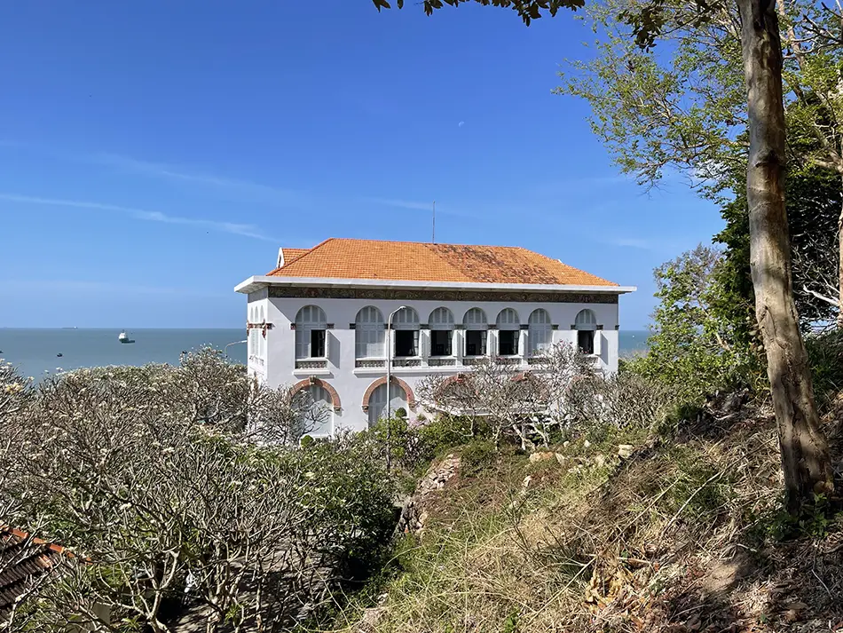 Elegant white colonial villa surrounded by green hills, a top attraction in Vung Tau.