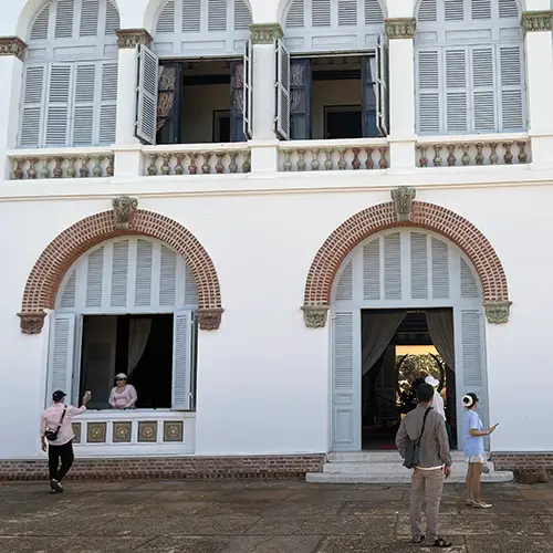 Grand arched entrance of the White Palace with classic French colonial architecture.