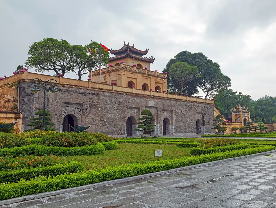 Historic stone gate and flag tower marking one of the top attractions in hanoi.