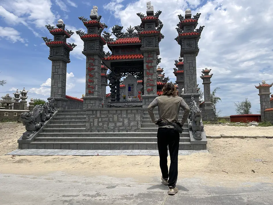 Large colorful family tombs and shrines forming a dense cemetery landscape, a hidden gem near Hue.