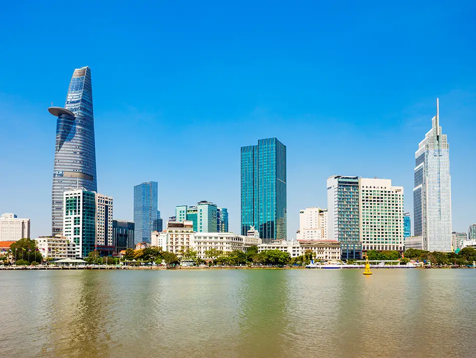 Modern skyscraper dominates the skyline along the river, highlighting things to see in Vietnam today.