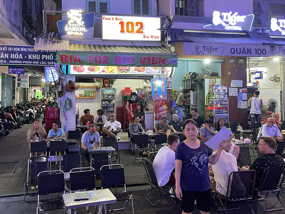 Crowded sidewalk bar serving cheap beer on Bui Vien, a lively spot in Ho Chi Minh Night Life.