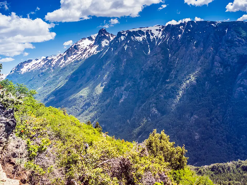 Mountain valley and forested slopes surrounding El Bolson in Patagonia, Argentina.