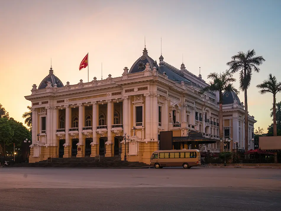 Elegant yellow neoclassical building representing the best things to do in hanoi for culture lovers.