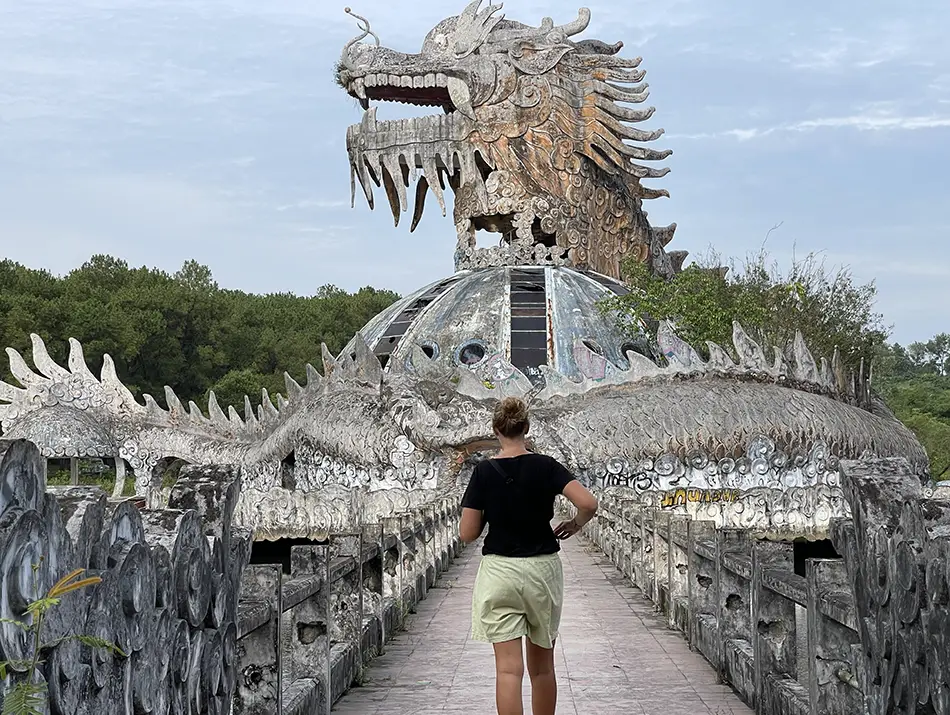 Concrete dragon sculpture and walkway inside an abandoned park, an off the beaten pass Hue day trip.