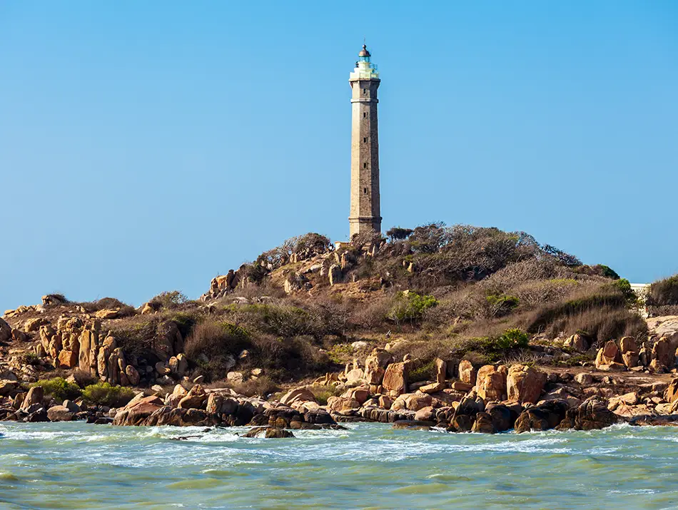 Ke Ga Lighthouse on a rocky island offshore, often considered the best day trip from Mui Ne.