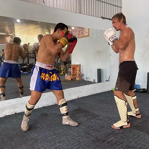 Two fighters practicing combinations during Muay Thai training at a local gym in Mui Ne, Vietnam.