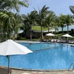 Relaxing by a beachfront resort pool, one of the best things to do in Mui Ne.