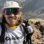 Guides and Stories traveler exploring off the beaten path hiking destinations in remote high mountains.