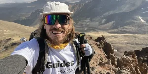 Guides and Stories traveler exploring off the beaten path hiking destinations in remote high mountains.