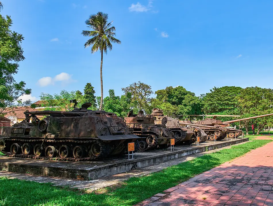 Open-air displays of military vehicles and equipment arranged across a museum yard.
