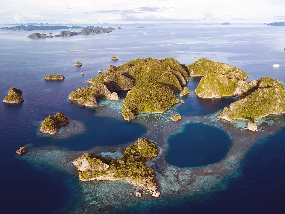 Karst islets and lagoons in Raja Ampat, highlighted as a classic scuba destination.