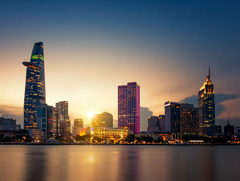 Skyscrapers reflected on the river at golden hour, showing one of the best sunset spots in Ho Chi Minh.