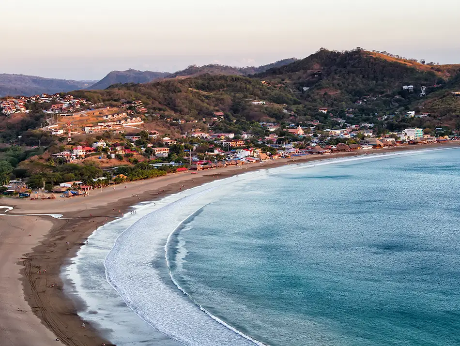 San Juan del Sur bay curving beachline in Nicaragua, popular for beginner surf.