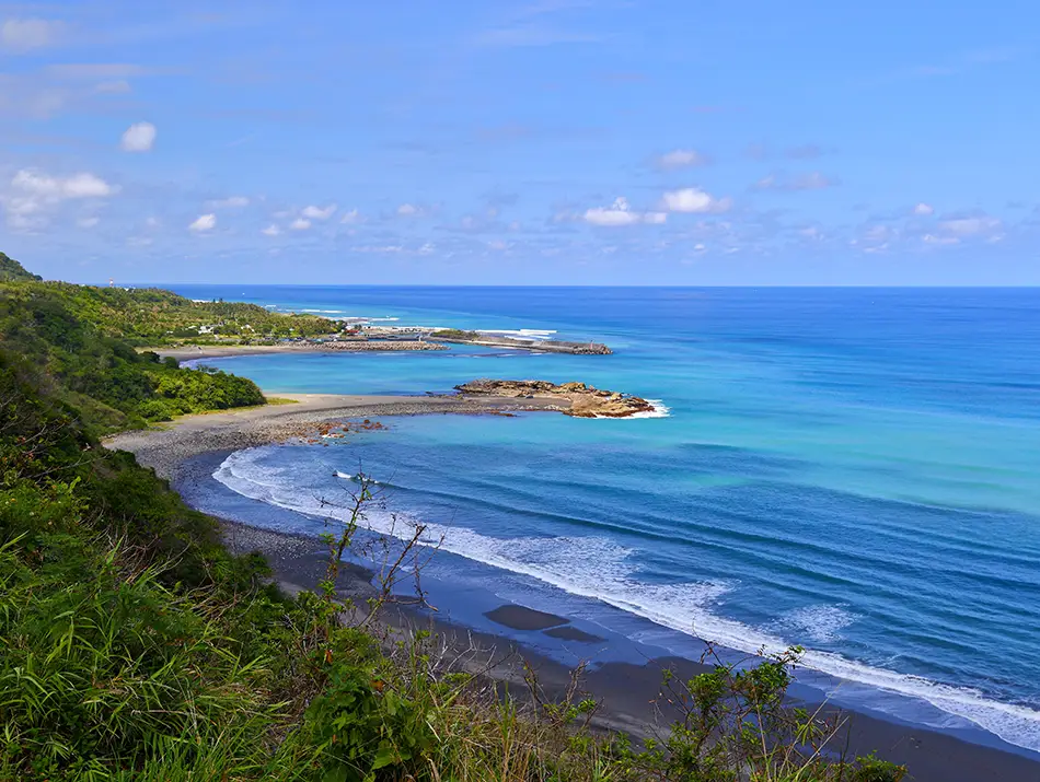 aitung coastline in Taiwan with turquoise bays and open-ocean surf breaks.