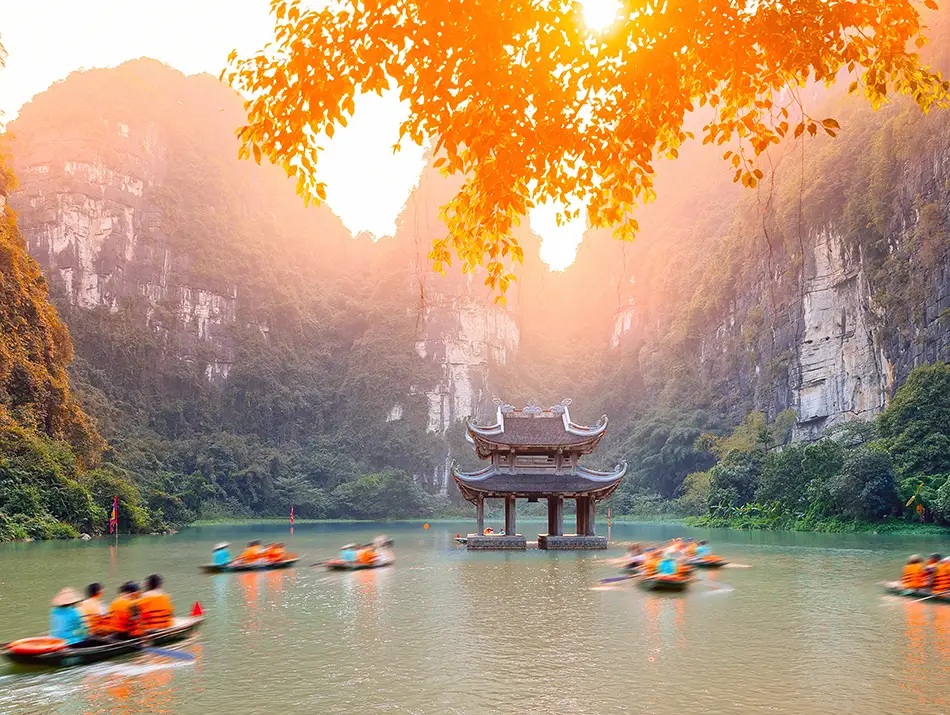 Rowboats move through limestone valleys and rivers of Trang An, part of Vietnam World Heritage
