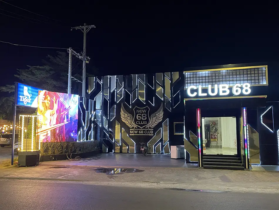 Neon-lit entrance of a Vina House nightclub, part of nightlife in Vietnam.
