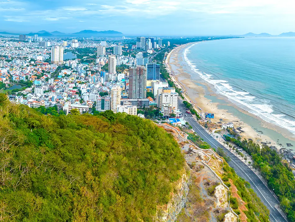 Aerial view of Vung Tau peninsula beaches and skyline.