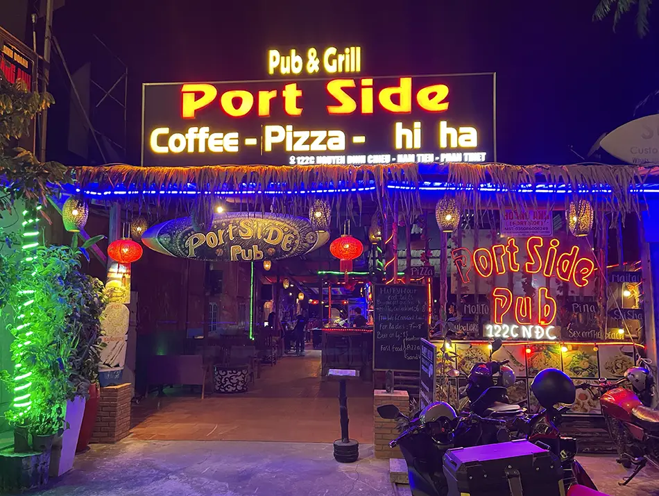 Illuminated Port Side Grill and Pub facade along the main street in Mui Ne.