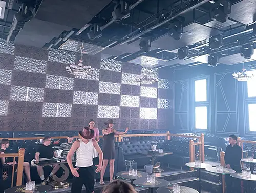 Checkerboard wall and bright ceiling lights over a mostly empty nightclub in Mui Ne.