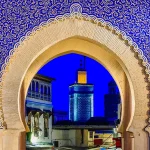 Illuminated Bab Bou Jeloud at night, one of the Top things to see in Fes.