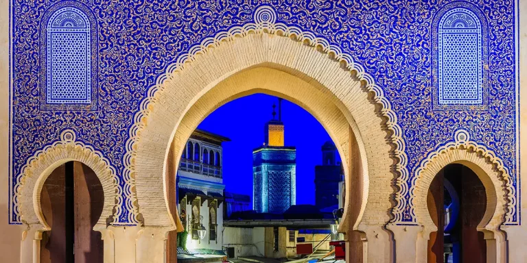 Illuminated Bab Bou Jeloud at night, one of the Top things to see in Fes.