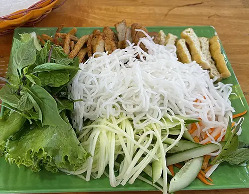 Bun Dau dish - Rice vermicelli with herbs, cucumber, and dipping sauce.