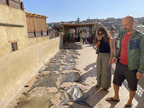 Tourists watching leather hides drying in the sun in Fes