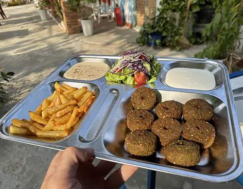 Falafel set with fries and salad, a staple at vegetarian restaurants in Mui Ne.