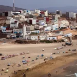 Coastal cliffs and whitewashed houses overlooking the Atlantic near Mirleft.