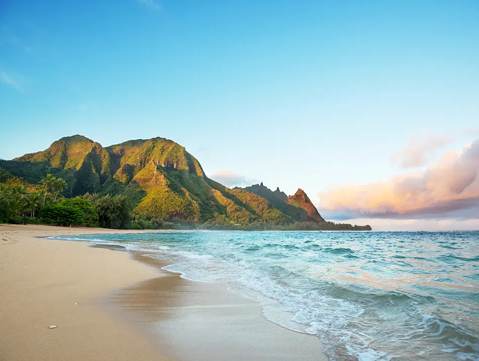 Golden beach and rugged mountains at Hanalei Bay, Kauai, popular for Set Jetting.