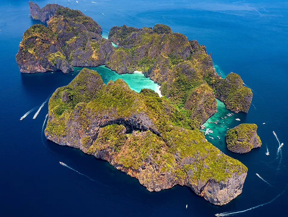 Aerial view of limestone islands and turquoise waters at Maya Bay, Thailand.