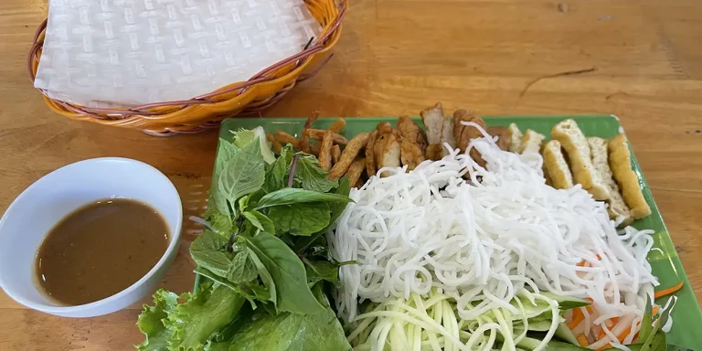 Rice noodles with herbs and dipping sauce, vegetarian food in mui ne.