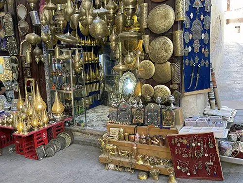 Handcrafted metal goods inside a traditional craft shop.