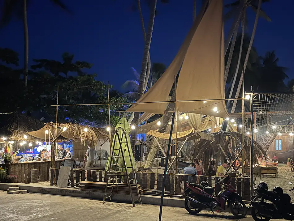 Beachfront venue lit at night with motorbikes parked outside, part of Mui Ne Nightlife.