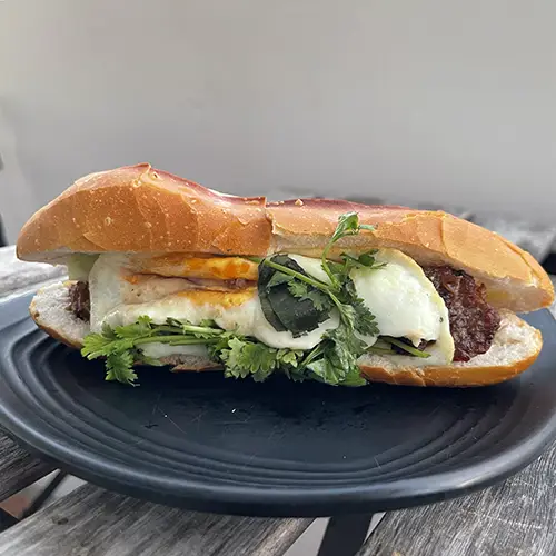 Crispy banh mi sandwich with herbs and pickles from the Best cafe in Mui Ne.