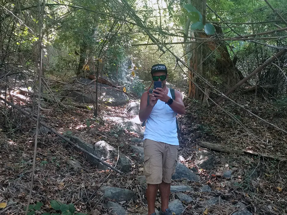 Traveler standing on a forest trail while hiking Ta Cu Mountain near Mui Ne Vietnam
