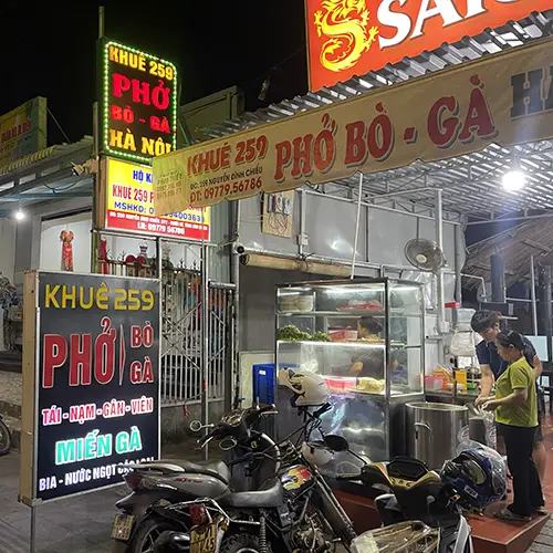 Neon-lit Khue 259 sign along the main road, of Mui Ne