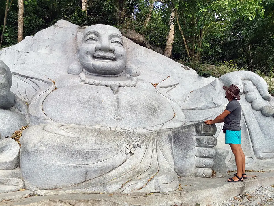 Large laughing Buddha statue carved in stone.