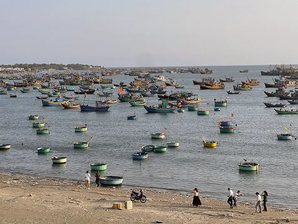 Basket fishing boats anchored near Mui Ne fishing village along the South China Sea coast.