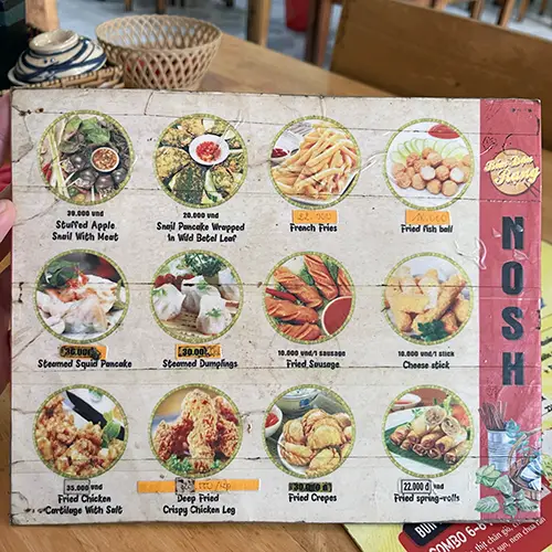 Illustrated menu board at an authentic cafe in Mui Ne showing local dishes and prices.