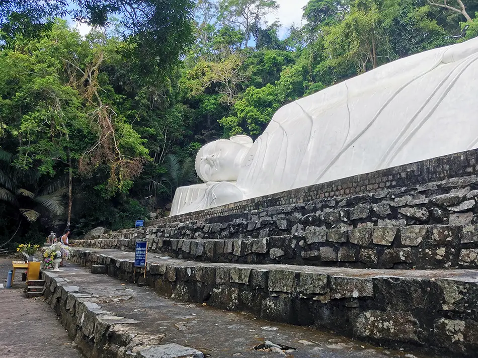 Reclining Buddha statue on Ta Cu Mountain surrounded by forest near Mui Ne Vietnam