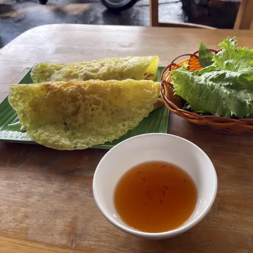 Crispy vegetarian banh xeo with herbs and dipping sauce among the best dishes to try in Mui Ne,