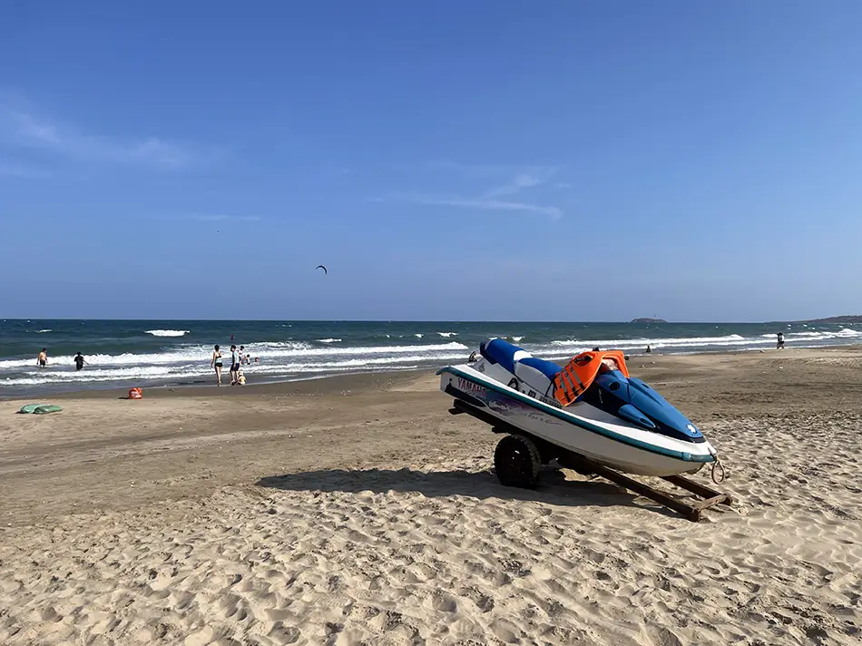 A rescue jet ski sitting idle on the sand