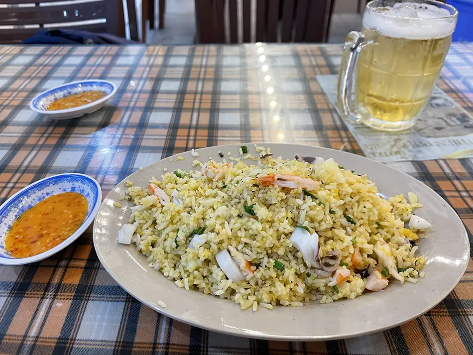 Plate of seafood fried rice served at a local Vung Tau restaurant, with visible vegetables and egg
